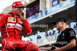 (L to R): Kimi Raikkonen (FIN) Ferrari with Valtteri Bottas (FIN) Mercedes AMG F1 on the drivers parade. 26.11.2017. Formula 1 World Championship, Rd 20, Abu Dhabi Grand Prix, Yas Marina Circuit, Abu Dhabi, Race Day.