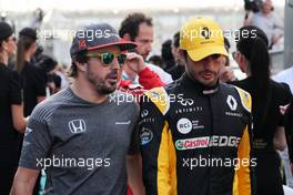 (L to R): Fernando Alonso (ESP) McLaren with Carlos Sainz Jr (ESP) Renault Sport F1 Team on the drivers parade. 26.11.2017. Formula 1 World Championship, Rd 20, Abu Dhabi Grand Prix, Yas Marina Circuit, Abu Dhabi, Race Day.
