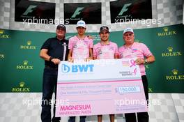 (L to R): Lutz Huebner, BWT? Marketing Chief; Sergio Perez (MEX) Sahara Force India F1; and Otmar Szafnauer (USA) Sahara Force India F1 Chief Operating Officer, as BWT donate $150,000 to the Breast Cancer Care charity. 21.10.2017. Formula 1 World Championship, Rd 17, United States Grand Prix, Austin, Texas, USA, Qualifying Day.