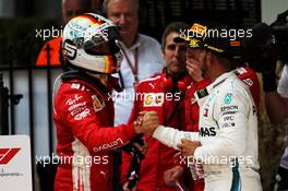(L to R): Race winner Sebastian Vettel (GER) Ferrari celebrates with Lewis Hamilton (GBR) Mercedes AMG F1 in parc ferme. 25.03.2018. Formula 1 World Championship, Rd 1, Australian Grand Prix, Albert Park, Melbourne, Australia, Race Day.