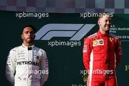 (L to R): second placed Lewis Hamilton (GBR) Mercedes AMG F1 and race winner Sebastian Vettel (GER) Ferrari on the podium. 25.03.2018. Formula 1 World Championship, Rd 1, Australian Grand Prix, Albert Park, Melbourne, Australia, Race Day.