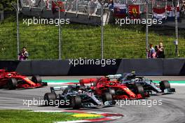 (L to R): Lewis Hamilton (GBR) Mercedes AMG F1 W09 with Kimi Raikkonen (FIN) Ferrari SF71H and Valtteri Bottas (FIN) Mercedes AMG F1 W09 at the start of the race. 01.07.2018. Formula 1 World Championship, Rd 9, Austrian Grand Prix, Spielberg, Austria, Race Day.