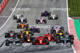 (L to R): Lewis Hamilton (GBR) Mercedes AMG F1 W09; Kimi Raikkonen (FIN) Ferrari SF71H; and Valtteri Bottas (FIN) Mercedes AMG F1 W09, at the start of the race. 01.07.2018. Formula 1 World Championship, Rd 9, Austrian Grand Prix, Spielberg, Austria, Race Day.