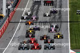 (L to R): Lewis Hamilton (GBR) Mercedes AMG F1 W09; Kimi Raikkonen (FIN) Ferrari SF71H; and Valtteri Bottas (FIN) Mercedes AMG F1 W09, at the start of the race. 01.07.2018. Formula 1 World Championship, Rd 9, Austrian Grand Prix, Spielberg, Austria, Race Day.