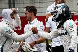 Valtteri Bottas (FIN) Mercedes AMG F1 (Right) celebrates his pole position with second placed team mate Lewis Hamilton (GBR) Mercedes AMG F1 (Left) in qualifying parc ferme. 30.06.2018. Formula 1 World Championship, Rd 9, Austrian Grand Prix, Spielberg, Austria, Qualifying Day.