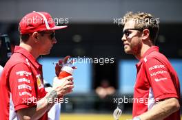 (L to R): Kimi Raikkonen (FIN) Ferrari with Sebastian Vettel (GER) Ferrari on the drivers parade. 01.07.2018. Formula 1 World Championship, Rd 9, Austrian Grand Prix, Spielberg, Austria, Race Day.