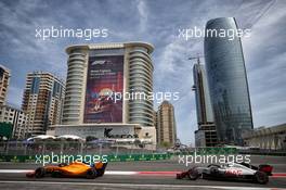 Fernando Alonso (ESP) McLaren MCL33 leads Romain Grosjean (FRA) Haas F1 Team VF-18. 27.04.2018. Formula 1 World Championship, Rd 4, Azerbaijan Grand Prix, Baku Street Circuit, Azerbaijan, Practice Day.