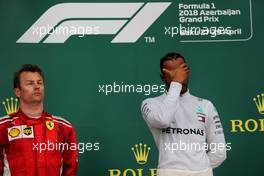 (L to R): Kimi Raikkonen (FIN) Ferrari with race winner Lewis Hamilton (GBR) Mercedes AMG F1 on the podium. 29.04.2018. Formula 1 World Championship, Rd 4, Azerbaijan Grand Prix, Baku Street Circuit, Azerbaijan, Race Day.