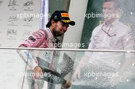 Sergio Perez (MEX) Sahara Force India F1 celebrates his third position with the champagne on the podium. 29.04.2018. Formula 1 World Championship, Rd 4, Azerbaijan Grand Prix, Baku Street Circuit, Azerbaijan, Race Day.