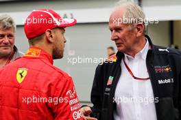 (L to R): Sebastian Vettel (GER) Ferrari with Dr Helmut Marko (AUT) Red Bull Motorsport Consultant. 29.04.2018. Formula 1 World Championship, Rd 4, Azerbaijan Grand Prix, Baku Street Circuit, Azerbaijan, Race Day.