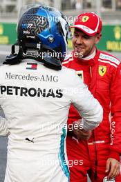 Sebastian Vettel (GER) Ferrari (Right) celebrates his pole position with third placed Valtteri Bottas (FIN) Mercedes AMG F1 in qualifying parc ferme. 28.04.2018. Formula 1 World Championship, Rd 4, Azerbaijan Grand Prix, Baku Street Circuit, Azerbaijan, Qualifying Day.