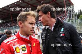 Sebastian Vettel (GER) Ferrari with Toto Wolff (GER) Mercedes AMG F1 Shareholder and Executive Director on the grid. 26.08.2018. Formula 1 World Championship, Rd 13, Belgian Grand Prix, Spa Francorchamps, Belgium, Race Day.