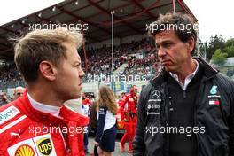 Sebastian Vettel (GER) Ferrari with Toto Wolff (GER) Mercedes AMG F1 Shareholder and Executive Director on the grid. 26.08.2018. Formula 1 World Championship, Rd 13, Belgian Grand Prix, Spa Francorchamps, Belgium, Race Day.