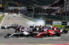 Lewis Hamilton (GBR) Mercedes AMG F1 W09 and Sebastian Vettel (GER) Ferrari SF71H lead at the start of the race. 26.08.2018. Formula 1 World Championship, Rd 13, Belgian Grand Prix, Spa Francorchamps, Belgium, Race Day.