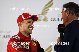 Race winner Sebastian Vettel (GER) Ferrari with David Coulthard (GBR) Red Bull Racing and Scuderia Toro Advisor / Channel 4 F1 Commentator on the podium. 08.04.2018. Formula 1 World Championship, Rd 2, Bahrain Grand Prix, Sakhir, Bahrain, Race Day.