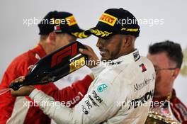 Lewis Hamilton (GBR) Mercedes AMG F1 celebrates his third position on the podium. 08.04.2018. Formula 1 World Championship, Rd 2, Bahrain Grand Prix, Sakhir, Bahrain, Race Day.