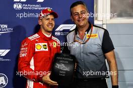 Sebastian Vettel (GER) Ferrari celebrates his pole position with Mario Isola (ITA) Pirelli Racing Manager. 07.04.2018. Formula 1 World Championship, Rd 2, Bahrain Grand Prix, Sakhir, Bahrain, Qualifying Day.