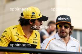 (L to R): Carlos Sainz Jr (ESP) Renault Sport F1 Team with Fernando Alonso (ESP) McLaren on the drivers parade. 08.04.2018. Formula 1 World Championship, Rd 2, Bahrain Grand Prix, Sakhir, Bahrain, Race Day.