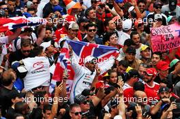 A Lewis Hamilton (GBR) Mercedes AMG F1 fan with other fans at the podium. 11.11.2018. Formula 1 World Championship, Rd 20, Brazilian Grand Prix, Sao Paulo, Brazil, Race Day.