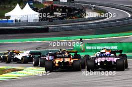 Esteban Ocon (FRA) Racing Point Force India F1 VJM11 and Stoffel Vandoorne (BEL) McLaren MCL33 at the start of the race. 11.11.2018. Formula 1 World Championship, Rd 20, Brazilian Grand Prix, Sao Paulo, Brazil, Race Day.