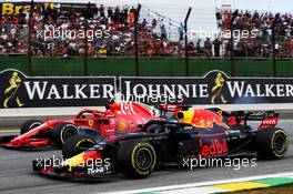 Sebastian Vettel (GER) Ferrari SF71H and Daniel Ricciardo (AUS) Red Bull Racing RB14 battle for position. 11.11.2018. Formula 1 World Championship, Rd 20, Brazilian Grand Prix, Sao Paulo, Brazil, Race Day.