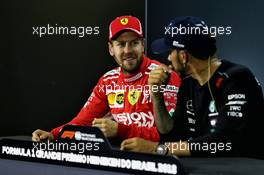 (L to R): Sebastian Vettel (GER) Ferrari with Lewis Hamilton (GBR) Mercedes AMG F1 in the post qualifying FIA Press Conference. 10.11.2018. Formula 1 World Championship, Rd 20, Brazilian Grand Prix, Sao Paulo, Brazil, Qualifying Day.