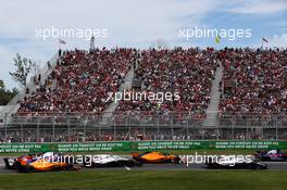 Lance Stroll (CDN) Williams FW41 leads Stoffel Vandoorne (BEL) McLaren MCL33 and Sergey Sirotkin (RUS) Williams FW41 at the start of the race. 10.06.2018. Formula 1 World Championship, Rd 7, Canadian Grand Prix, Montreal, Canada, Race Day.