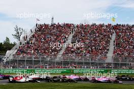 Esteban Ocon (FRA) Sahara Force India F1 VJM11 leads Sergio Perez (MEX) Sahara Force India F1 VJM11 and Carlos Sainz Jr (ESP) Renault Sport F1 Team RS18 at the start of the race. 10.06.2018. Formula 1 World Championship, Rd 7, Canadian Grand Prix, Montreal, Canada, Race Day.