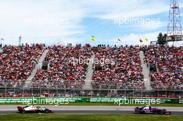 Pierre Gasly (FRA) Scuderia Toro Rosso STR13 leads Romain Grosjean (FRA) Haas F1 Team VF-18. 10.06.2018. Formula 1 World Championship, Rd 7, Canadian Grand Prix, Montreal, Canada, Race Day.