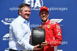 Sebastian Vettel (GER) Ferrari receives the Pirelli Pole Position Award from Paul Hembery (GBR) Pirelli Motorsport Director in qualifying parc ferme. 09.06.2018. Formula 1 World Championship, Rd 7, Canadian Grand Prix, Montreal, Canada, Qualifying Day.