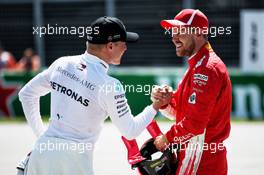 Sebastian Vettel (GER) Ferrari (Right) celebrates his pole position in qualifying parc ferme with second placed Valtteri Bottas (FIN) Mercedes AMG F1. 09.06.2018. Formula 1 World Championship, Rd 7, Canadian Grand Prix, Montreal, Canada, Qualifying Day.