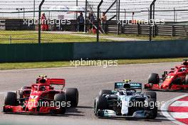 Valtteri Bottas (FIN) Mercedes AMG F1 W09 and Kimi Raikkonen (FIN) Ferrari SF71H battle for position. 15.04.2018. Formula 1 World Championship, Rd 3, Chinese Grand Prix, Shanghai, China, Race Day.