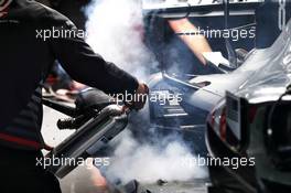 Romain Grosjean (FRA) Haas F1 Team VF-18 with fire extinguisher pointed at the rear brakes.