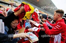 Sebastian Vettel (GER) Ferrari signs autographs for the fans. 12.04.2018. Formula 1 World Championship, Rd 3, Chinese Grand Prix, Shanghai, China, Preparation Day.