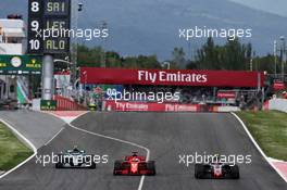 (L to R): Valtteri Bottas (FIN) Mercedes AMG F1 W09 leaves the pits as Sebastian Vettel (GER) Ferrari SF71H overtakes Kevin Magnussen (DEN) Haas VF-18. 13.05.2018. Formula 1 World Championship, Rd 5, Spanish Grand Prix, Barcelona, Spain, Race Day.