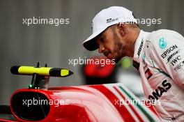 Lewis Hamilton (GBR) Mercedes AMG F1 looks at the Ferrari SF71H of Kimi Raikkonen (FIN) Ferrari in qualifying parc ferme. 12.05.2018. Formula 1 World Championship, Rd 5, Spanish Grand Prix, Barcelona, Spain, Qualifying Day.