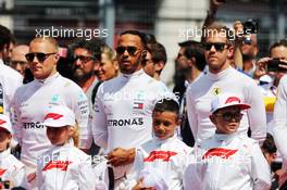 (L to R): Valtteri Bottas (FIN) Mercedes AMG F1; Lewis Hamilton (GBR) Mercedes AMG F1, and Sebastian Vettel (GER) Ferrari, as the grid observes the national anthem. 24.06.2018. Formula 1 World Championship, Rd 8, French Grand Prix, Paul Ricard, France, Race Day.