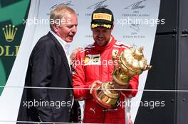 Race winner Sebastian Vettel (GER) Ferrari on the podium with Martin Brundle (GBR) Sky Sports Commentator. 08.07.2018. Formula 1 World Championship, Rd 10, British Grand Prix, Silverstone, England, Race Day.