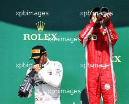 (L to R): Lewis Hamilton (GBR) Mercedes AMG F1 celebrates on the podium with race winner Sebastian Vettel (GER) Ferrari. 08.07.2018. Formula 1 World Championship, Rd 10, British Grand Prix, Silverstone, England, Race Day.