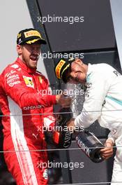 (L to R): Race winner Sebastian Vettel (GER) Ferrari celebrates on the podium with Lewis Hamilton (GBR) Mercedes AMG F1. 08.07.2018. Formula 1 World Championship, Rd 10, British Grand Prix, Silverstone, England, Race Day.