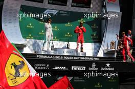 (L to R): Lewis Hamilton (GBR) Mercedes AMG F1; Kimi Raikkonen (FIN) Ferrari, and race winner Sebastian Vettel (GER) Ferrari, on the podium. 08.07.2018. Formula 1 World Championship, Rd 10, British Grand Prix, Silverstone, England, Race Day.