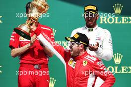 Race winner Sebastian Vettel (GER) Ferrari celebrates on the podium with second placed Lewis Hamilton (GBR) Mercedes AMG F1. 08.07.2018. Formula 1 World Championship, Rd 10, British Grand Prix, Silverstone, England, Race Day.