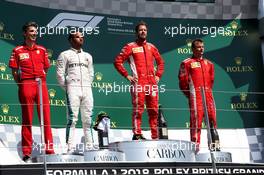 The podium (L to R): Lewis Hamilton (GBR) Mercedes AMG F1, second; Sebastian Vettel (GER) Ferrari, race winner; Kimi Raikkonen (FIN) Ferrari, third. 08.07.2018. Formula 1 World Championship, Rd 10, British Grand Prix, Silverstone, England, Race Day.