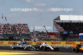 Lewis Hamilton (GBR) Mercedes AMG F1 W09 and Sergey Sirotkin (RUS) Williams FW41 battle for position. 08.07.2018. Formula 1 World Championship, Rd 10, British Grand Prix, Silverstone, England, Race Day.