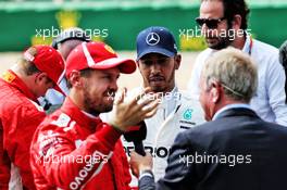 (L to R): Sebastian Vettel (GER) Ferrari with Lewis Hamilton (GBR) Mercedes AMG F1 and Martin Brundle (GBR) Sky Sports Commentator in qualifying parc ferme. 07.07.2018. Formula 1 World Championship, Rd 10, British Grand Prix, Silverstone, England, Qualifying Day.