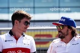 (L to R): Charles Leclerc (MON) Sauber F1 Team with Fernando Alonso (ESP) McLaren on the drivers parade. 08.07.2018. Formula 1 World Championship, Rd 10, British Grand Prix, Silverstone, England, Race Day.