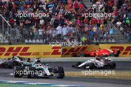 Sebastian Vettel (GER) Ferrari SF71H crashed out of the race and is passed by Lewis Hamilton (GBR) Mercedes AMG F1 W09. 22.07.2018. Formula 1 World Championship, Rd 11, German Grand Prix, Hockenheim, Germany, Race Day.
