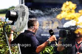 Frank Montangy (FRA) Canal+ TV Presenter cools off next to a fan. 20.07.2018. Formula 1 World Championship, Rd 11, German Grand Prix, Hockenheim, Germany, Practice Day.