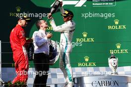 (L to R): Sebastian Vettel (GER) Ferrari celebrates with the champagne his second position on the podium with race winner Lewis Hamilton (GBR) Mercedes AMG F1. 29.07.2018. Formula 1 World Championship, Rd 12, Hungarian Grand Prix, Budapest, Hungary, Race Day.