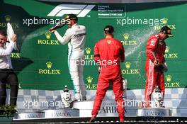 (L to R): Race winner Lewis Hamilton (GBR) Mercedes AMG F1 celebrates with the champagne on the podium with second placed Sebastian Vettel (GER) Ferrari and third placed Kimi Raikkonen (FIN) Ferrari. 29.07.2018. Formula 1 World Championship, Rd 12, Hungarian Grand Prix, Budapest, Hungary, Race Day.